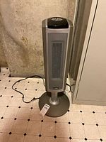 Full view of Lasko pedestal tower heater showing overall condition and power cord