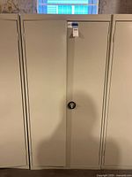 Front view of beige two-door metal cabinet closed