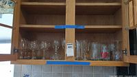 Open cabinet showing full assortment of goblets, tumblers and crystal pieces