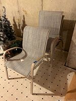 Four stackable patio chairs showing overall style and color