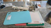 Overview of all items: mixer, immersion blender, cutting boards, boxed electric knife