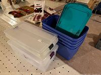 Stack of clear and blue totes with lids