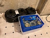 TRU triple slow cooker behind blue crate of canning jars, can opener and tape visible