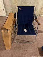 Chair set up next to boxed folded chair
