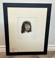 Framed portrait photograph with mat and frame visible
