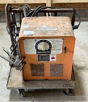 Front view of Arcweld 225 welder on cart showing cables