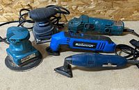 Group shot of all four corded power tools on bench