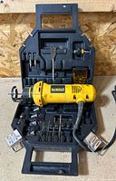 Overall view of Dewalt DW660 tool inside case with bits and sockets