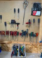 Full pegboard view showing screwdrivers, mixer paddle, Jobmate pouch and bins of additional screwdrivers