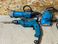 Three Makita corded tools grouped together