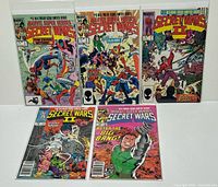 Front covers of all five bagged and boarded comics displayed upright and flat