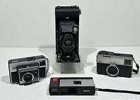 Group shot of four Kodak cameras: Instamatic 133, No.1A Pocket Folding, Instamatic X-35, Pocket Instamatic 20
