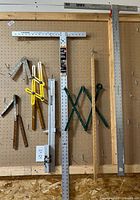 Overview of measuring tools hanging on pegboard