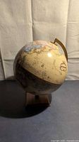 Full view of Globemaster globe on wood base
