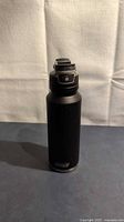 Full view of black Coleman stainless steel water bottle