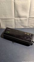 Top view of black FoodSaver FM2000 vacuum sealer showing control buttons and logo