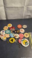 Group of assorted vintage Canadian pins and buttons on table