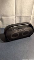 Front view of black Onn Bluetooth speaker with handle and control buttons