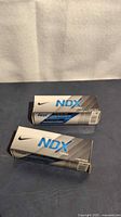 Two Nike NDX Turbo golf ball sleeves on surface