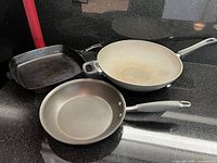Top view of three pans showing shapes and interior surfaces