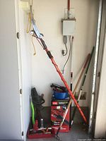 Overall lot showing Toro blower box, pole pruner, and assortment of long and short handle tools