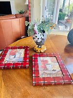 Lot overview: rooster planter with faux greenery and two framed coffee prints on tabletop