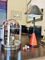 Globe clock, desk lamp and one animal figurine on desk
