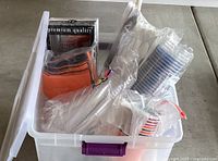 Clear tote with plastic cups, cutlery, FoodSaver bags