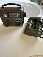 Front view of Grundig FR-200 radio and binoculars side-by-side