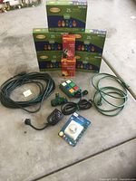 All items laid out: five LED light boxes, two mini light boxes, two extension cords, power strip, timer, controller