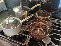 Group shot of four saucepans on stovetop