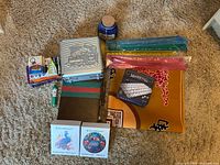 Overview showing aluminium case, card games, wooden puzzles, mahjong set, fabric cover, plastic tubes and coin bank