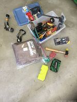 Full lot showing tote with hand tools, mallet, tape, headlamp, nozzle, tarp, drill-bit cases