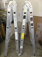 Full view of folded articulating ladder standing