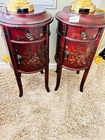 Front view showing both red floral nightstands with drawer and cabinet