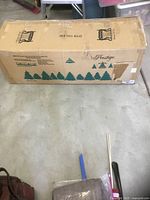 Sealed shipping box showing brand and tree graphics