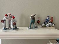 Front view of all four figurines on shelf