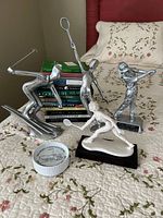 Group view of figurines, books stack and trinket box