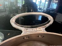 Close-up of Sur La Table handle on stainless pot