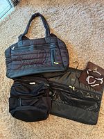 All four travel pieces displayed: quilted tote, backpack, garment organizer open, suede pouch