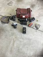 Full view of cameras, lenses, bag and accessories spread on floor