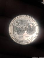 Reverse of 1974 Winnipeg centennial Canadian dollar coin