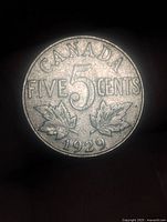 Reverse of 1929 Canada 5 cent coin showing denomination and date