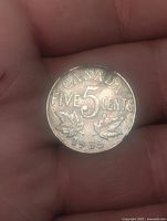Reverse showing CANADA FIVE 5 CENTS, maple leaves and 1935 date