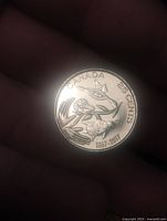 Reverse of 2017 Canada 25-cent coin showing birds motif and legends