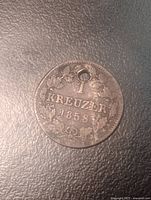 Reverse side showing 1 Kreuzer, date 1858, toning, holed