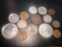 All fourteen coins laid out, obverse sides visible