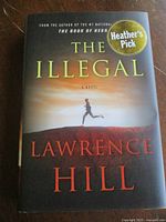 Front cover of "The Illegal" hardcover with dust jacket and Heather's Pick sticker