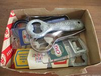 Box containing assorted vintage beer advertising bottle openers