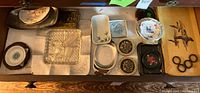 overview of assorted trays, dishes and coasters in drawer